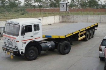 Low-bed trailer transporting heavy equipment